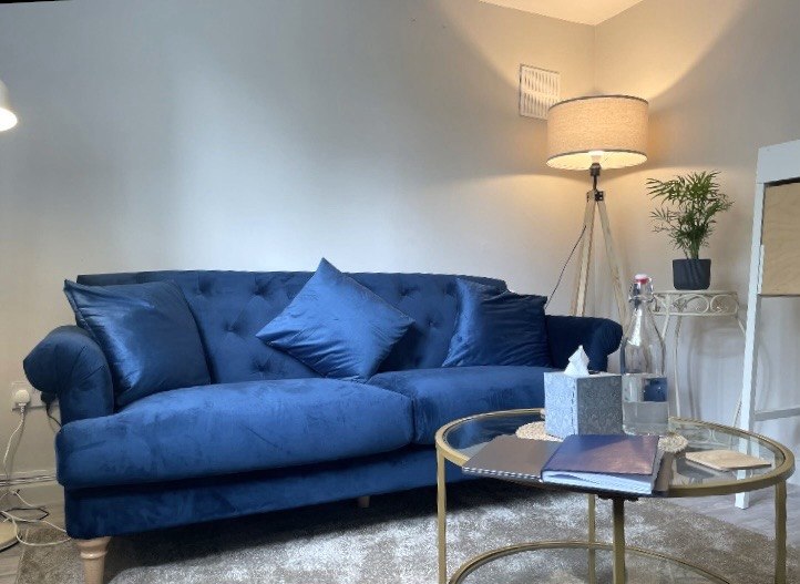 Blue sofa and warm lamp in the London therapy room