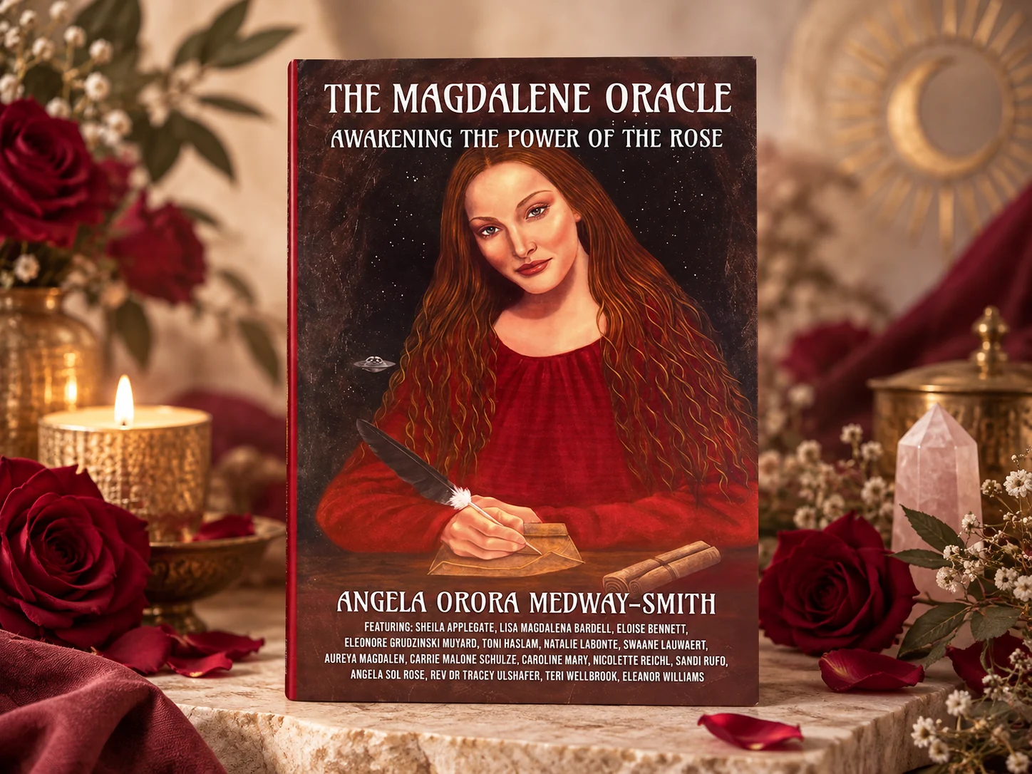 The Magdalene Oracle book displayed with burgundy roses, candlelight and a rose quartz crystal.